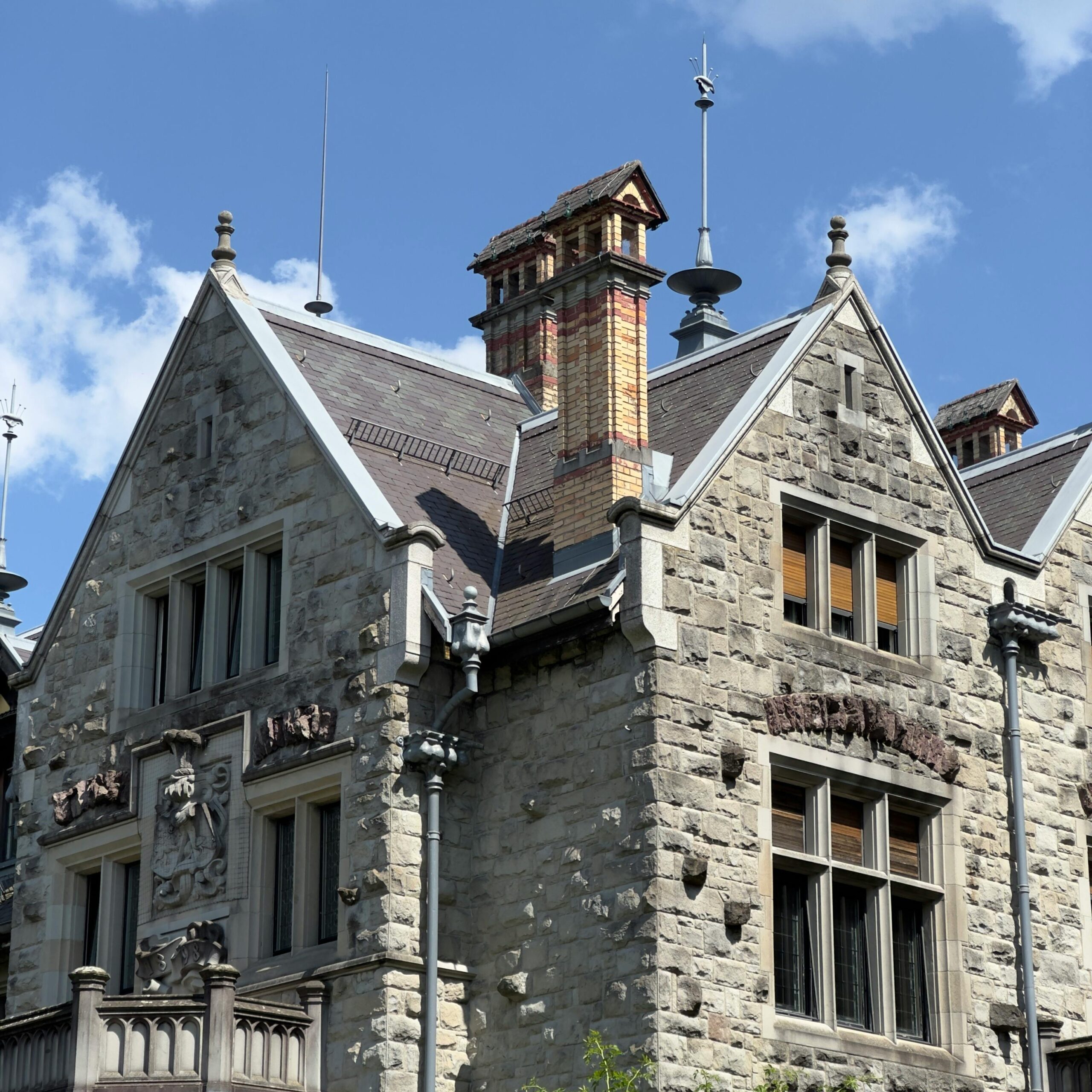 Beautiful stone building with intricate details in Zürich, Switzerland under a clear blue sky